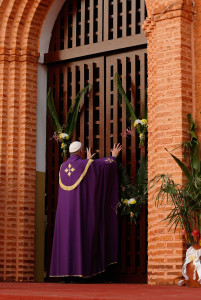 Pope Francis opens the Holy Door as he begins the Holy Year of Mercy at the start of a Mass with priests, religious, catechists and youths at the cathedral in Bangui, Central African Republic, Nov. 29. (CNS photo/Paul Haring)
