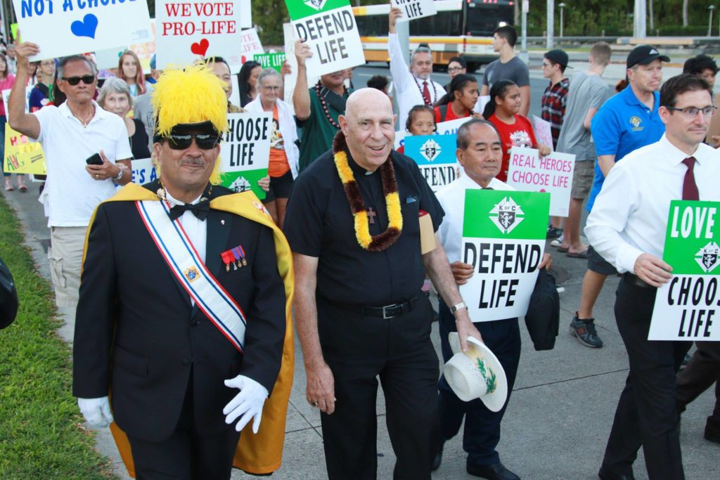 March for Life marchers with signs and walking